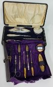 A cased silver manicure set, hallmarked Birmingham 1918, together with another manicure set, white
