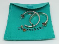 A pair of Tiffany & Co. silver hoop earrings, diameter 2.5cm, together with a single silver stud,