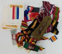 A collection of 20th century military medal ribbons and a shoulder epaulette.