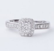 A platinum ring set with a central radiant cut diamond, approx. 0.35 carats, surrounded by round
