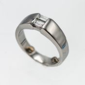 A platinum wide band ring, set with two baguette cut diamonds in a half rubover setting, approx