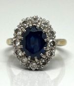 An 18ct yellow gold sapphire and diamond cluster ring, size J.