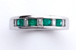 An 18ct white gold half eternity style ring set with four round cut emeralds, total weight approx.