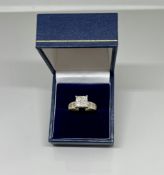 An impressive 14k yellow diamond ring, set with an arrangement of princess cut diamonds, size M.