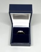 An 18ct gold three stone diamond ring, size P.