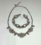 A fancy silver marquisate bracelet and necklace.