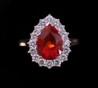 An 18ct yellow & white gold pear shaped cluster ring set with a central pear shaped fire opal,
