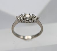 A seven stone diamond ring set in 18ct white gold, size P.