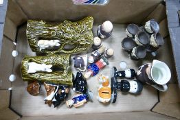 A mixed collection of items to include Sylvac tree stump jugs, Milky Bars Advertising money box,