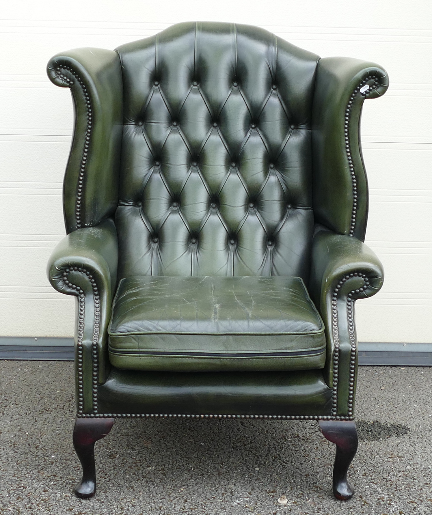 Green leather Queen Anne Chesterfield high back armchair, some slight wear to cushion.