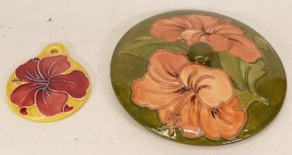 Moorcroft Hibiscus lid on green ground together with Hibiscus pendant on yellow ground (a/f) (2)