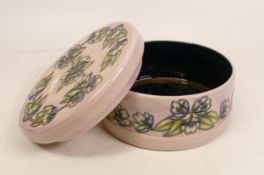 Moorcroft circular lidded pot decorated with purple flowers on lilac ground. M.C.C 2003 , diameter