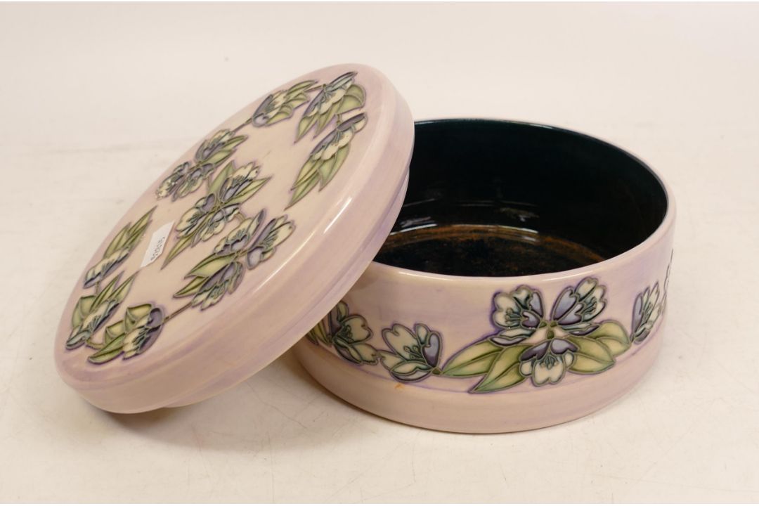 Moorcroft circular lidded pot decorated with purple flowers on lilac ground. M.C.C 2003 , diameter