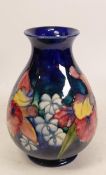 Moorcroft Orchid vase on blue ground. Height 21cm