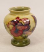 Moorcroft Orchid footed vase on faded yellow/green ground. Height 9cm