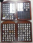 A collection of thimbles to include golliwog, seasons, advertising, robin hood, Beatles, etc (4)