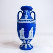 Early 20th century Wedgwood dark blue dipped jasperware two handled urn & cover, decorated with