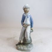 Lladro figure of Boy leaning on bollard with pond yacht, h.23.5cm.
