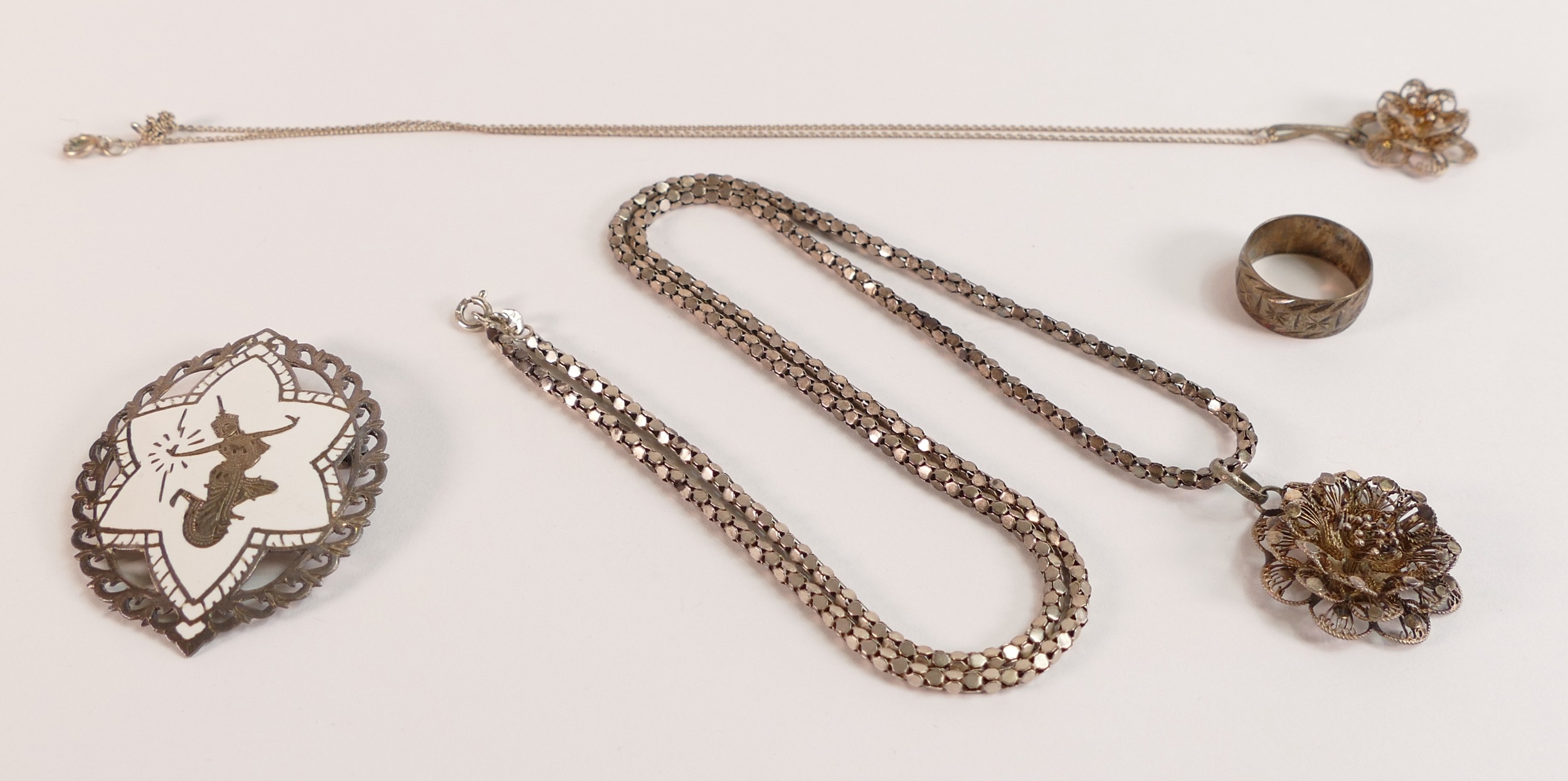 Two Silver filigree floral pendant and chains, Siam brooch and a silver wedding ring, 34.5g. (4)