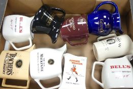A collection of Wade water jugs to include Grants, Johnny Walker, Bell's, Teachers, Highland