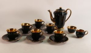 A 15 Piece Wade coffee set in black with gold painted interior. These items form part the collection