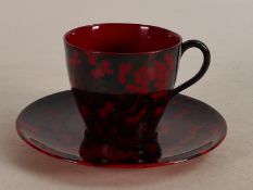 Royal Doulton Flambe coffee can & saucer decorated in the prunus design, c1920.