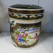 20th Century Chinese export porcelain tea caddie and cover decorated with Garden scenes, h.15cm.