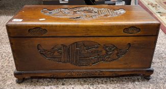 A Small Chinese Camphor Wood Chest with Heavily Carved Oriental Scenes. Height: 32cm Length: 67cm