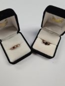 9ct yellow gold garnet set ring with central oval garnet flanked with a round cut example each side,