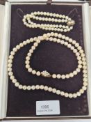 A single strand of cultured pearls, with 9ct gold clasp, together with a silver gilt clasp double st