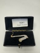 Pretty 18ct two tone brooch in the form of a Saxophone, the body encrusted with diamonds, marked 750