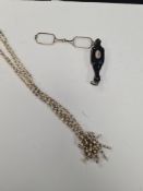 An antique strand of pearls with yellow metal spacers and a pair of lorgnettes