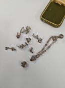 A silver charm bracelet and a quantity of silver charms, a 9ct gold clasp single strand of simulated