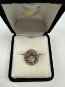 Antique yellow gold cluster ring with raised central oval mixed cut amethyst above scalloped panel i