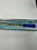 Tiffany & Co; a cased Sterling Silver letter opener by Tiffany & Co., with royal blue guilloche enam
