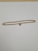 9ct gold dress stud, marked 9c, approx 0.5g, on a rolled gold belcher chain