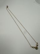 9ct yellow gold chain with central pendant in the form of a flower head, with central rubover set di