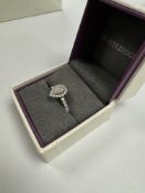 An as new beautiful Platinum and diamond ring with central pear shaped diamond, brilliant round cut