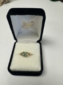 10ct yellow gold emerald and diamond ring, with central small diamond surrounded by 4 round cut emer