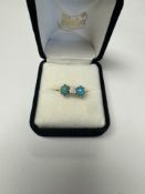 Attractive yellow gold trilogy ring with central round cut diamond approx 0.25 carat with an oval cl