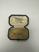 Pretty antique twin bar brooch, with central flower head decoration central ruby surrounded seed pea