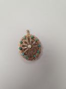 14K Rose gold pendant/brooch of oval form with filigree panel, central pearl surrounded 10 turquoise