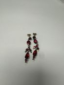 Pair of yellow gold drop earrings, inset with rose cut red paste, unmarked 4.3g approx