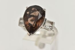 A GEM SET RING, designed as a central pear shape smokey quartz flanked by rectangular shape white