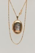 A 9CT GOLD OVAL LOCKET AND CHAIN, bi-colour oval locket with foliate pattern, opens to reveal two