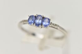 A 14CT WHITE GOLD TANZANITE AND DIAMOND RING, three oval cut tanzanite, each four claw set, small
