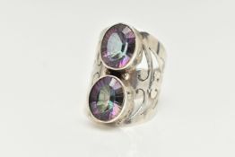 A LARGE WHITE METAL MYSTIC QUARTZ DRESS RING, collet set with two oval cut mystic coated quartz,
