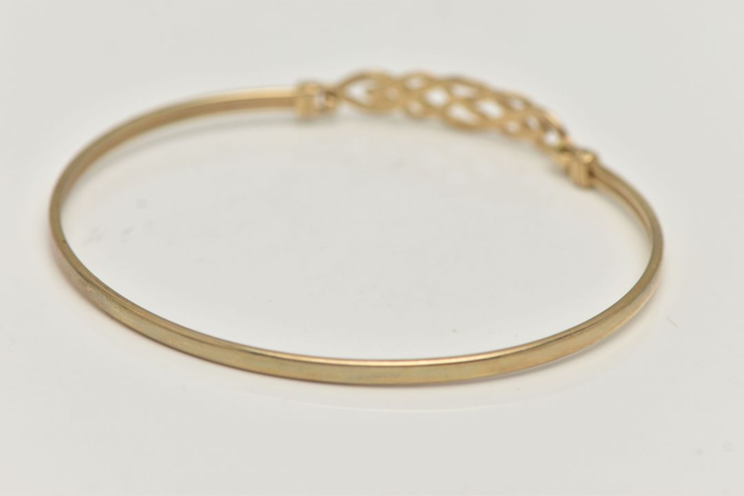 A 9CT GOLD BANGLE, a Celtic design light weight bangle, fitted with a hook fastening, hallmarked 9ct - Image 4 of 4