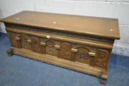 A CARVED OAK BLANKET CHEST, with iron drop handles, width 123cm x depth 49cm x height 47cm (