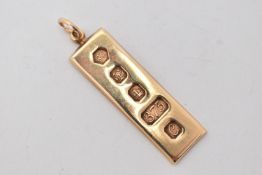 A 9CT GOLD INGOT PENDANT, a rectangular form pendant with decorative hallmarks, approximate length